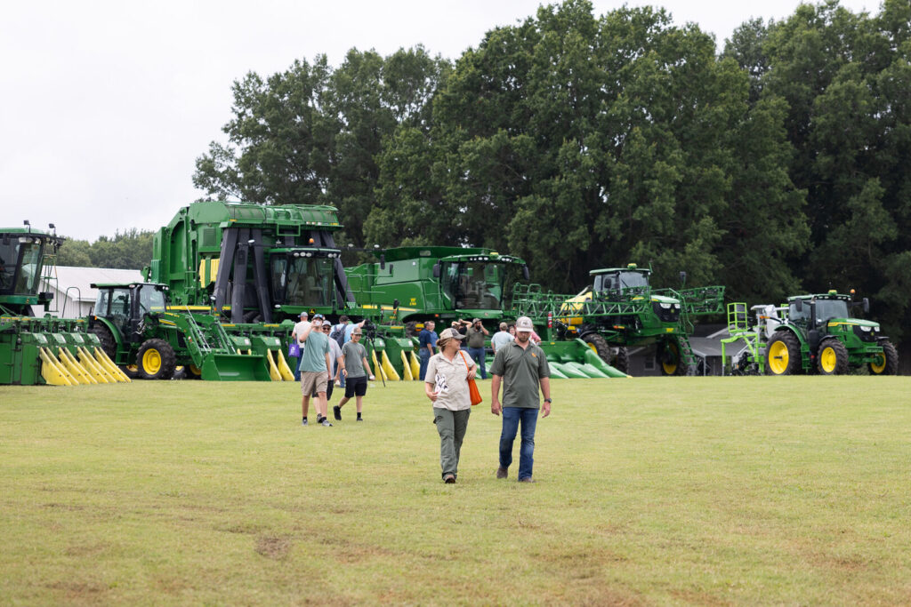 The photo displays the outdoor area with harvest equipment in the background.
