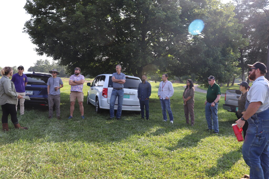 The photo features Organic Grain Unit Team addressing the NC1178 Multi-State Project Team.