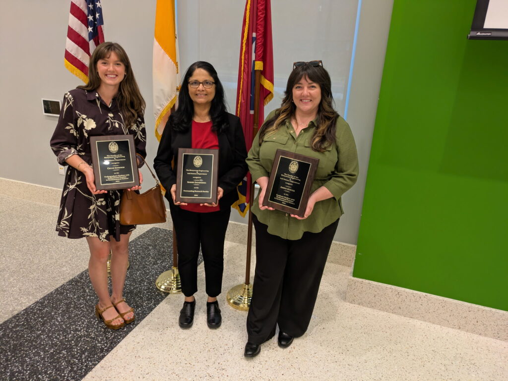 Callie on the left, Dr. Jagadamma in the center, and Amber on the right stand with their awards at the BESS awards banquet 2026