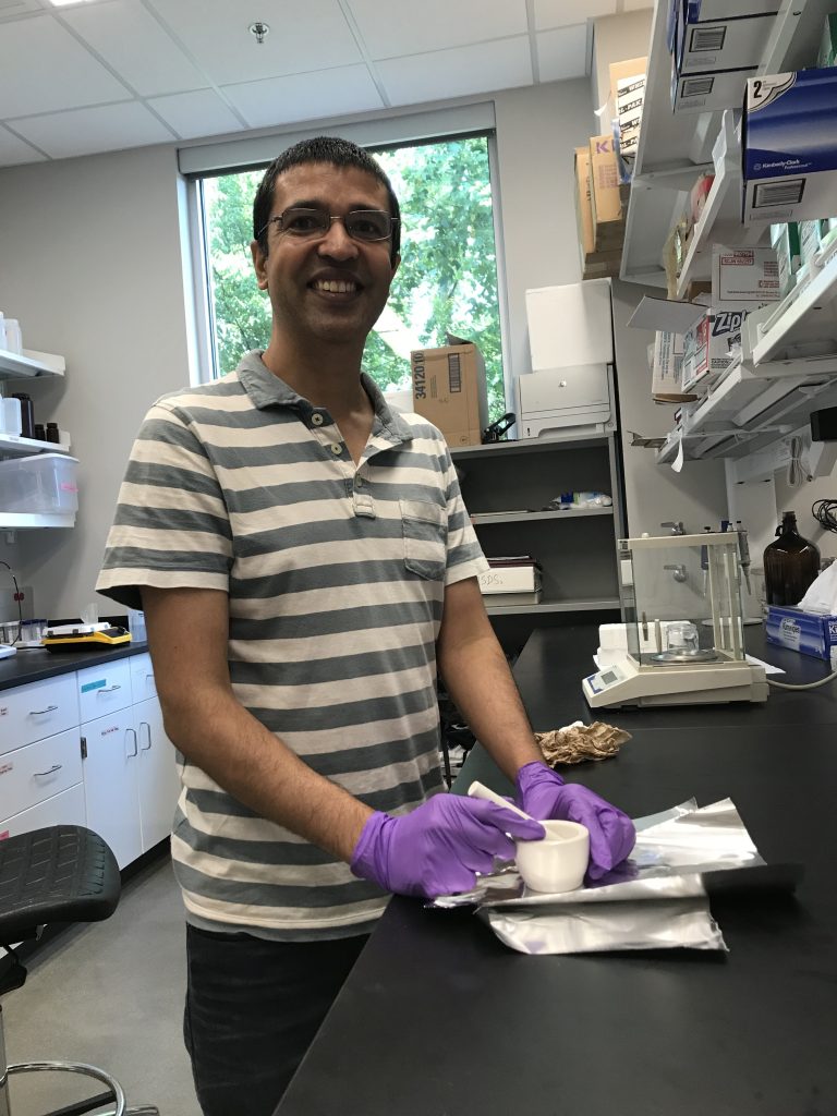 Dr. Avishesh Neupane pictured with a sample in the lab