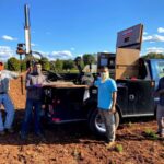 Researchers pictured with hydraulic probe in the field.