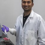 PhD candidate Rounak Patra photo taken in the lab with a sample.