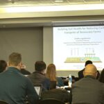 A photo of Dr. Jagadamma presenting to the audience at the TN State University.