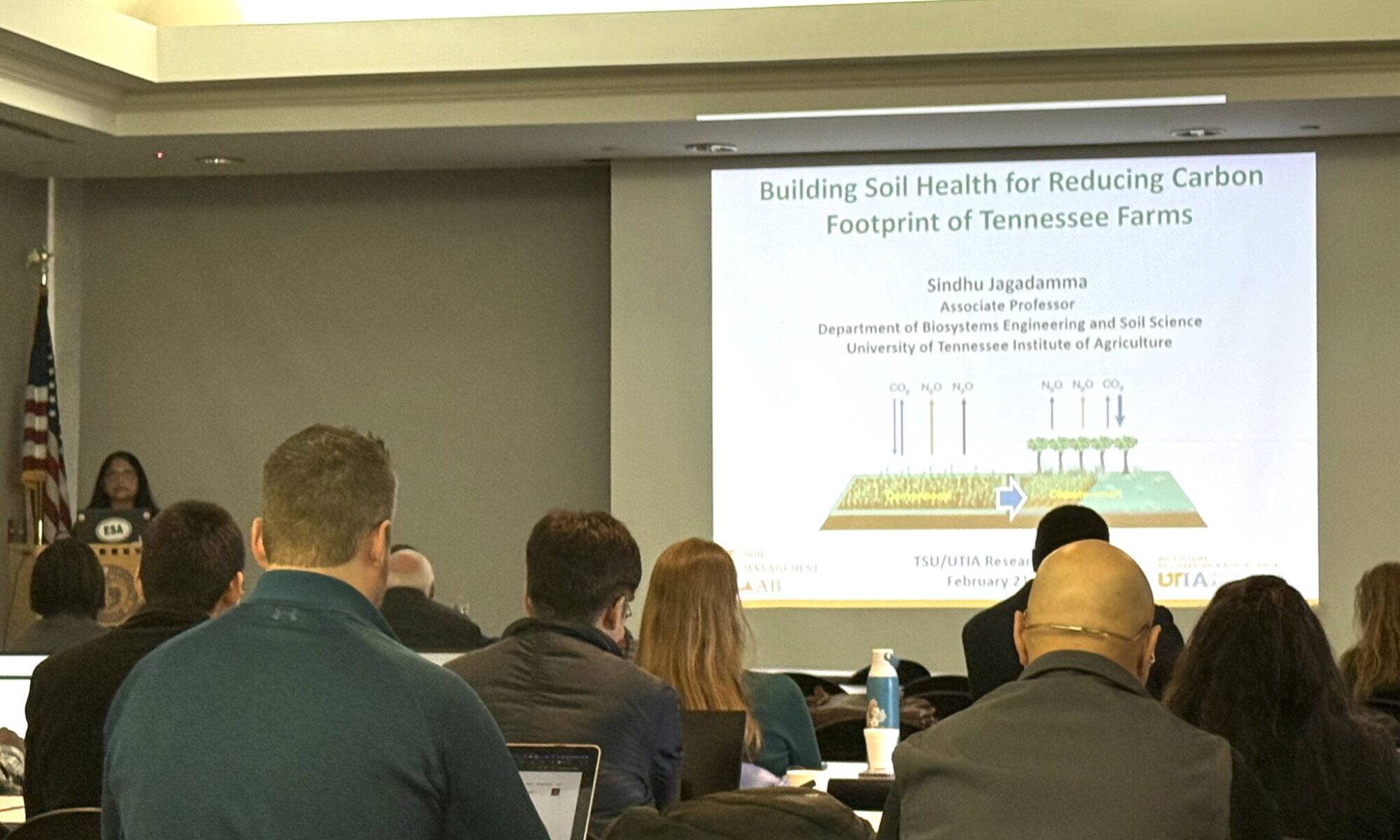 A photo of Dr. Jagadamma presenting to the audience at the TN State University.
