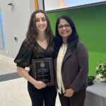 The photo presents Dr. Jagadamma (right) with Cecelia (right), carrying her graduate student with the Professional Promise Award.