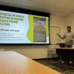 Picture features Dr. Neelipally presenting his research focus during a 3 x 3 presentation competition in the lab