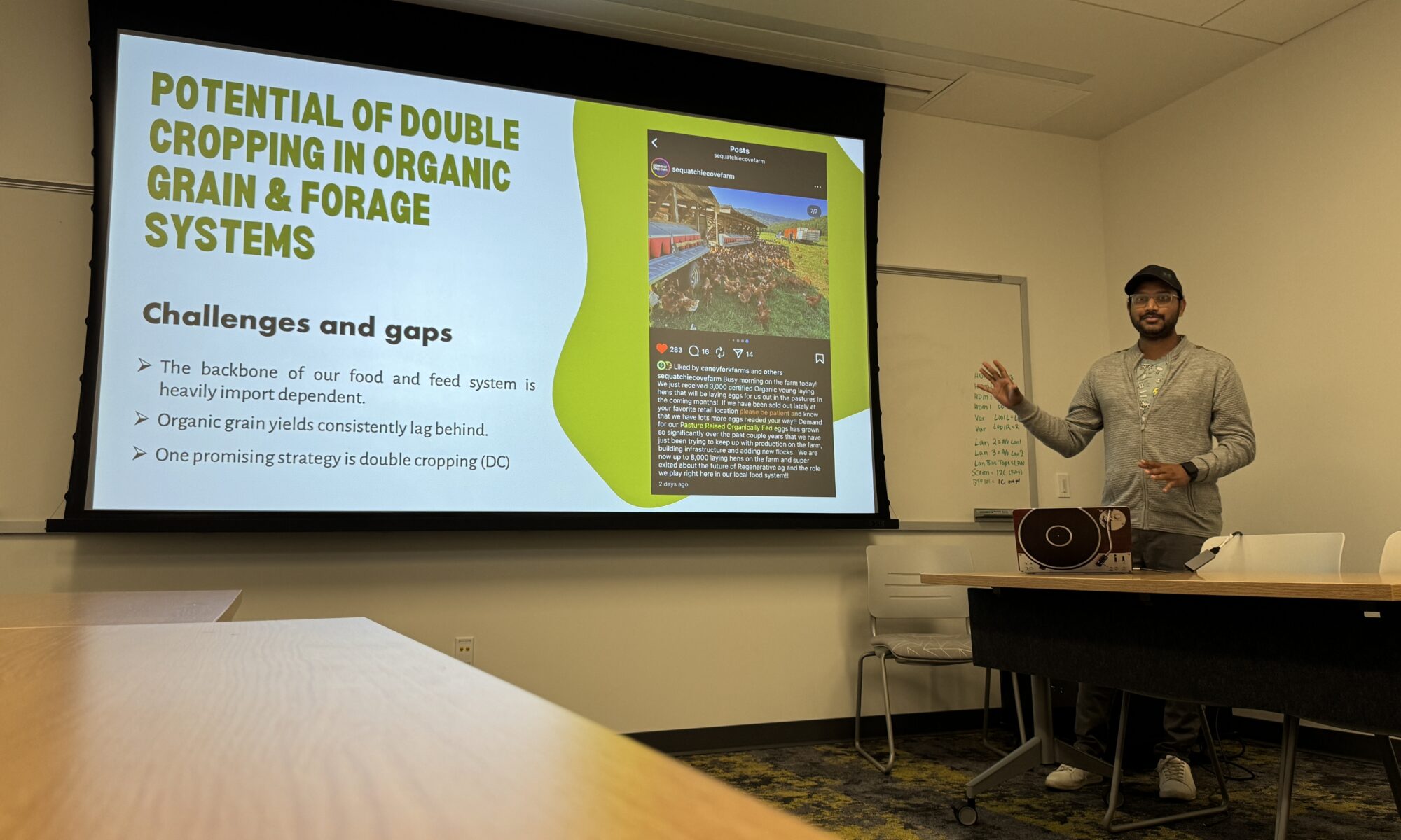Picture features Dr. Neelipally presenting his research focus during a 3 x 3 presentation competition in the lab