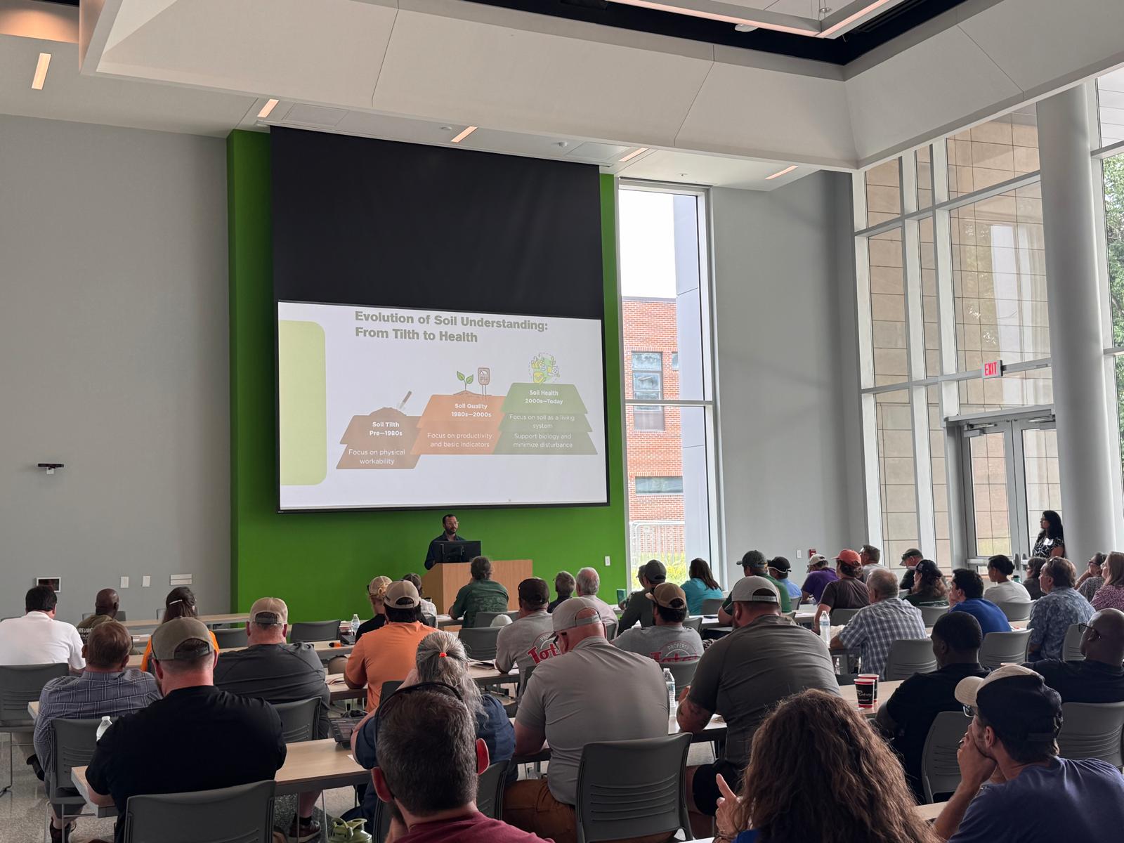 This photo features Dr. Neelipally presenting to the audience regarding the evolution of soil health understanding at the Green Industry Field Day 2025.
